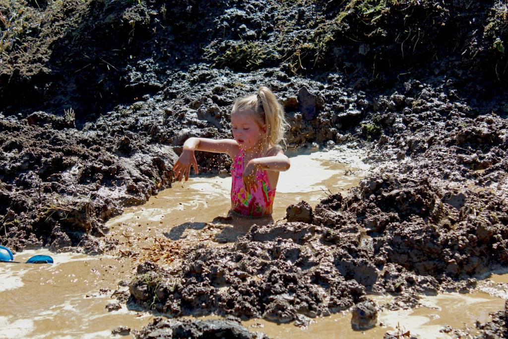 Photo by Megan Pacer/Homer News Isla Brown, 4, splashes in a pool of muddy water during this year&rsquo;s Mud Wallow on Saturday, July 22, 2017 at Cottonwood Horse Park in Homer, Alaska.