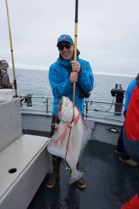 Øisten Stokke Berget of Trondheim, Norway, holds a halibut he caught while fishing on the North Country Charters fishing boat Irish on July 16, 2017 out of Homer Alaska. Photo by Michael Armstrong/Homer News