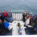 Anglers stand by a rack of halibut on the Irish as the North Country Charters boat returns to Homer. The 16 people fishing on the 53-foot boat all limited out on a July 16, 2017 guided halibut fishing trip out of Homer Alaska . Photo by Casey McKinnon
