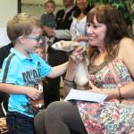 Photo by Megan Pacer/Homer News Homer resident Jeannette Aragones introduces her ferret, Oscar, to Jack Roderick during a special reading of her book, &ldquo;I Am Oscar. I Am in Charge.&rdquo; on Friday, July 21, 2017 at the Girassol Learning Center in Homer, Alaska.