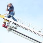 Kachemak Emergency Services firefighter Jason Miller looks through a pair of binoculars near the Baycrest Overlook on Monday, July 24, 2017 in Homer, Alaska. First responders found a pickup truck that had fallen over the edge of the bluff after hitting a guardrail, and searched for a possible victim until getting a report that the driver had crashed several days earlier and had walked away uninjured. Photo by Megan Pacer/Homer News