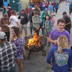 People stand around a fire pit on Saturday night, Aug. 5, 2017, at Salmonfest, Ninilchik, Alaska. (Photo by Michael Armstrong, Homer News)