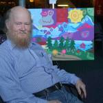 Art from the soul Travelling folk artist Walter Hudson, 74, of Linchburg, Va., sits next to one of his paintings at Refuge Chapel last Friday during an opening reception. Many of his paintings have religious meanings and symbols. &ldquo;They all have specific meaning,&rdquo; Hudson said. &ldquo;I spend a day thinking about them.&rdquo; The painting behind him is of Homer and Kachemak Bay. His work is on sale at Refuge Chapel. (Photo by Michael Armstrong, Homer News)