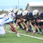 Members of the Homer Mariners varsity football team face off against those from Kodiak High School during their game Saturday, Aug. 12, 2017 at Homer High School in Homer, Alaska. Kodiak defeated the Mariners 21-8. (Photo by Megan Pacer/Homer News)