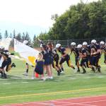 Members of the Homer Mariners varsity football team take the field for their game Saturday, Aug. 12, 2017 at Homer High School in Homer, Alaska. The Mariners lost to Kodiak 21-8. (Photo by Megan Pacer/Homer News)