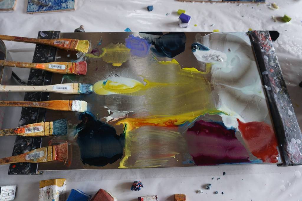 Encaustic paint and media is heated on a special hot-plate palette on July 30, 2017 at Ann-Margret Wimmerstedt&rsquo;s home. Pigmented wax is mixed with encaustic media made of beeswax and damar, resin for pine trees. Colors can be used alone or mixed with other colors. A paintbrush is used for each color. (Photo by Michael Armstrong/Homer News)