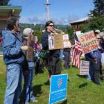 People demonstrating against the events of Charlottesville, Va., and other white supremacist rallies stand up against racism at WKFL Park in Homer on Sunday afternoon. About 50 people attended the one-hour event held from 3-4 p.m. Sunday, Aug. 13, 2017 in Homer, Alaska. (Photo by Michael Armstrong, Homer News)