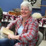 Karen Porter, a member of the Fireweed Fiber Guild, prepares some fibers while spinning yarn with other guild members Friday, Aug. 18, 2017 at this year&rsquo;s Kenai Peninsula Fair in Ninilchik, Alaska. (Photo by Megan Pacer/Homer News)