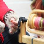 Lisa Lambert, a member of the Fireweed Fiber Guild, spins yard Friday, Aug. 18, 2017 at the Kenai Peninsula Fair in Ninilchik, Alaska. Members of the guild had tables and information at the fair and demonstrated yarn spinning from many kinds of natural fibers. (Photo by Megan Pacer/Homer News)