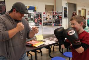 Guro Kurt P. Leffler II, left, head coach of K-Bay Martial Athletics, takes some practice swings from Elliott Greet at the Aug. 16 Youth After School Activities and Programs event sponsored by K-Bay Community Youth and Activities Coalition. (Photo by McKibben Jackinsky, for the Homer News)