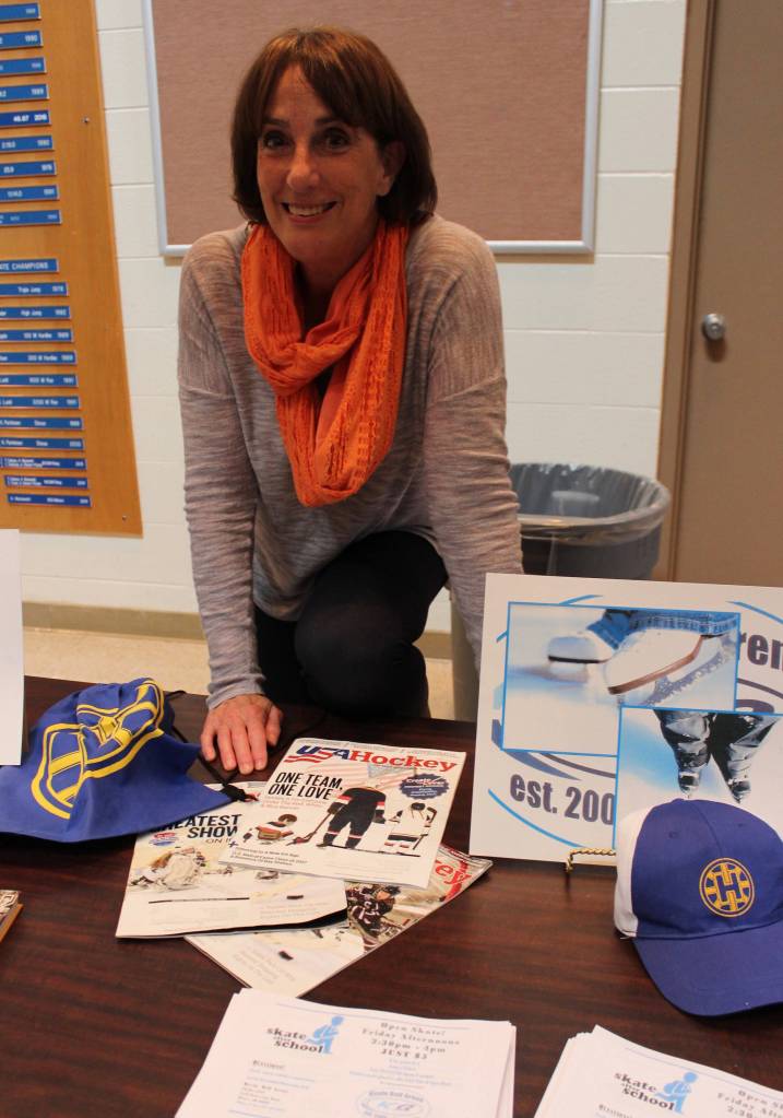 Melanie Dufour wears more than one hat. Not only is she the outreach director for Center for Alaskan Coastal Studies, Dufour also represented Homer Hockey Association at the Aug. 16 Youth After School Activities and Programs event sponsored by K-Bay Community Youth and Activities Coalition. (Photo by McKibben Jackinsky for the Homer News)