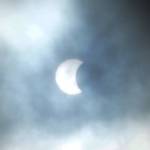Clouds parted briefly over Homer, Alaska, at about 8:45 a.m. during a partial eclipse of the sun in this view taken from Diamond Ridge on Monday, Aug. 21, 2017. (Photo by Michael Armstrong, Homer News)