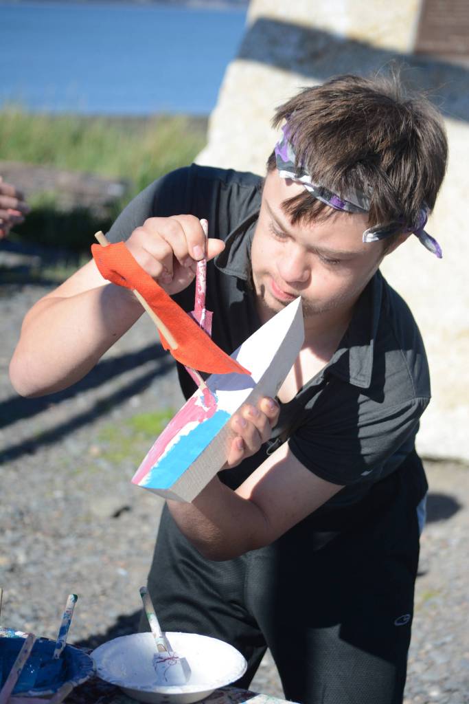 Espen Restad paints a wooden boat at a previous Kachemak Bay Wooden Boat Festival on the Spit. (Homer News file photo)