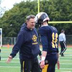 Walter Love, head coach of the Homer High School varsity football team, high-fives his players as the take the field at the end of their victorious game over Valdez High School on Saturday, Aug. 26, 2017 in Homer, Alaska. They topped the Buccaneers 66-0. (Photo by Megan Pacer/Homer News)
