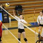 Sophomore Kelli Bishop tips the ball over the net during the Homer Mariners varsity volleyball team&rsquo;s game against Kenai Central High School on Tuesday, Aug. 29, 2017 at Homer High School in Homer, Alaska. The Mariners beat the Cardinals three games to zero in their first home match. (Photo by Megan Pacer/Homer News)