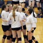 Players on the Homer Mariners varsity volleyball team celebrate after winning the first of three straight games in their set against Kenai Central High School on Tuesday, Aug. 29, 2017 at Homer High School in Homer, Alaska. The non-conference win was the first game of the season for the Mariners. (Photo by Megan Pacer/Homer News)