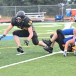 Offensive and defensive lineman Nikit Anufriev, a senior, dives for a fumbled ball during the Voznesenka Cougars&rsquo; game against Monroe Catholic High School on Saturday, Aug. 26, 2017 at the Homer Mariners&rsquo; field in Homer, Alaska. The Fairbanks team defeated Voznesenka 26-0. (Photo by Megan Pacer/Homer News)