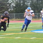 Senior David Sanarov runs the ball for the Voznesenka Cougars during their game against Monroe Catholic High School on Saturday, Aug. 26, 2017 at the Homer Mariners field in Homer, Alaska. The Fairbanks team crushed the Cougars 26-0. (Photo by Megan Pacer/Homer News)