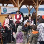 Erin Searcy-Dudgeon Wells of Rogues & Wenches, center, leads a sing along at the Kachemak Bay Wooden Boat Society Festival on Saturday, Sept. 2, 2017 at the Nick Dudiak Fishing Lagoon campground in Homer, Alaska. At left are Lucia Woofter and Lena Gonzales. At far right is Hunter Woofter, Devin Frey, second from right, and Bob Woofter. (Photo by Michael Armstrong, Homer News)