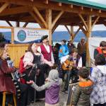 Erin Searcy-Dudgeon Wells of Rogues & Wenches, center, leads a sing along at the Kachemak Bay Wooden Boat Society Festival on Saturday, Sept. 2, 2017 at the Nick Dudiak Fishing Lagoon campground in Homer, Alaska. At left are Lucia Woofter and Lena Gonzales. At far right is Hunter Woofter, Devin Frey, second from right, and Bob Woofter. (Photo by Michael Armstrong, Homer News)