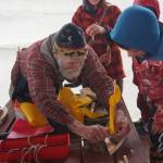 John Miles, left, helps Ike Mitchell work on a boat during the Kachemak Bay Wooden Boat Society Festival on Saturday, Sept. 2, 2017 at the Nick Dudiak Fishing Lagoon campground in Homer, Alaska. Ike&rsquo;s mother, Jamey Cloud, and his brother, Charlie Mitchell, watch. (Photo by Michael Armstrong, Homer News)