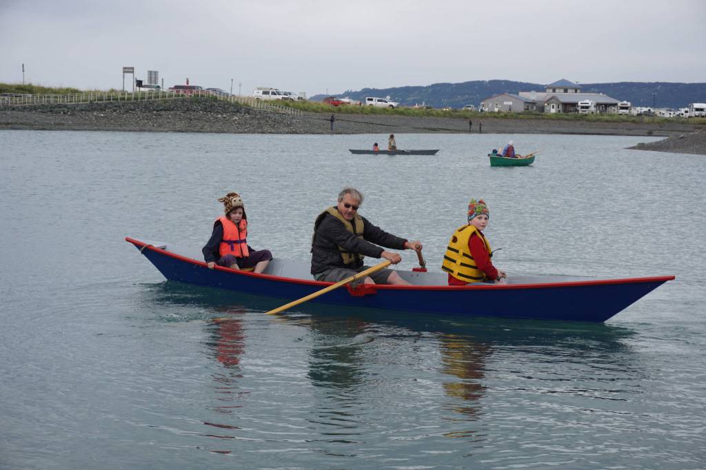 Charlie Barnwell, center, takes Anna Morphis and Richard Morphis for a boat ride during the Kachemak Bay Wooden Boat Society Festival on Saturday, Sept. 2, 2017 at the Nick Dudiak Fishing Lagoon campground in Homer, Alaska. (Photo by Michael Armstrong, Homer News)