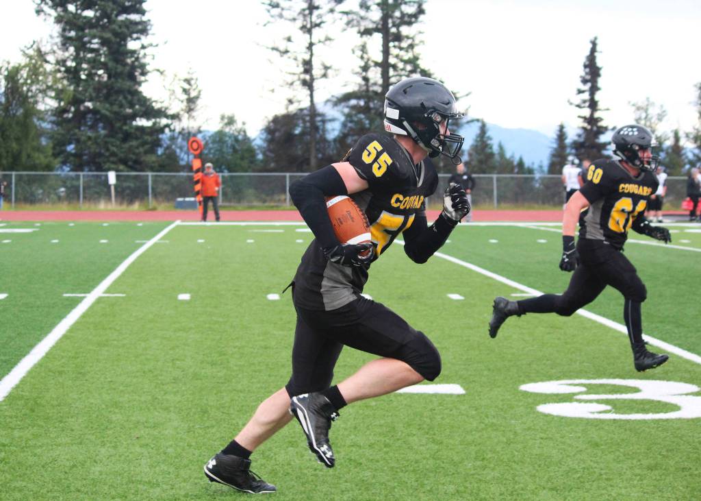 Offensive and defensive lineman Nikit Anufriev, one of two seniors on this year&rsquo;s Cougar football team, runs with the ball during the Cougars&rsquo; game against Nikiski High School on Saturday, Sept. 2, 2017 in Homer, Alaska. The Cougars lost 18-40. (Photo by Megan Pacer/Homer News)