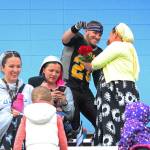 Voznesenka senior David Sanarov gives flowers to his mother during the senior night celebration before the Cougars football game against Joe Redington Jr/Sr High School on Friday, Sept. 15, 2017 at Homer High School in Homer, Alaska. (Photo by Megan Pacer/Homer News)