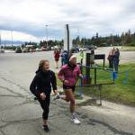 Homer Mariner swimmers Adeline Berry, left and Alia Bales cross the finish line of the Homer Mariner Triathlon on Saturday, Sept. 2, 2017 at the high school in Homer, Alaska. The two tied for fourth place in the 13-17 age group. (Photo courtesy Paul Story)