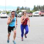 Anchorage resident Brian Shumaker and Kristin Faulkner, who used to swim for Homer High School before she went to college and then moved to New York, race each other to the finish line of the Homer Mariner Triathlon at Homer High School on Saturday, Sept. 2, 2017 in Homer, Alaska. The two remained on each other&rsquo;s tail throughout much of the race before Shumaker passed Faulkner at the last second to claim first overall. (Photo by Megan Pacer/Homer News)
