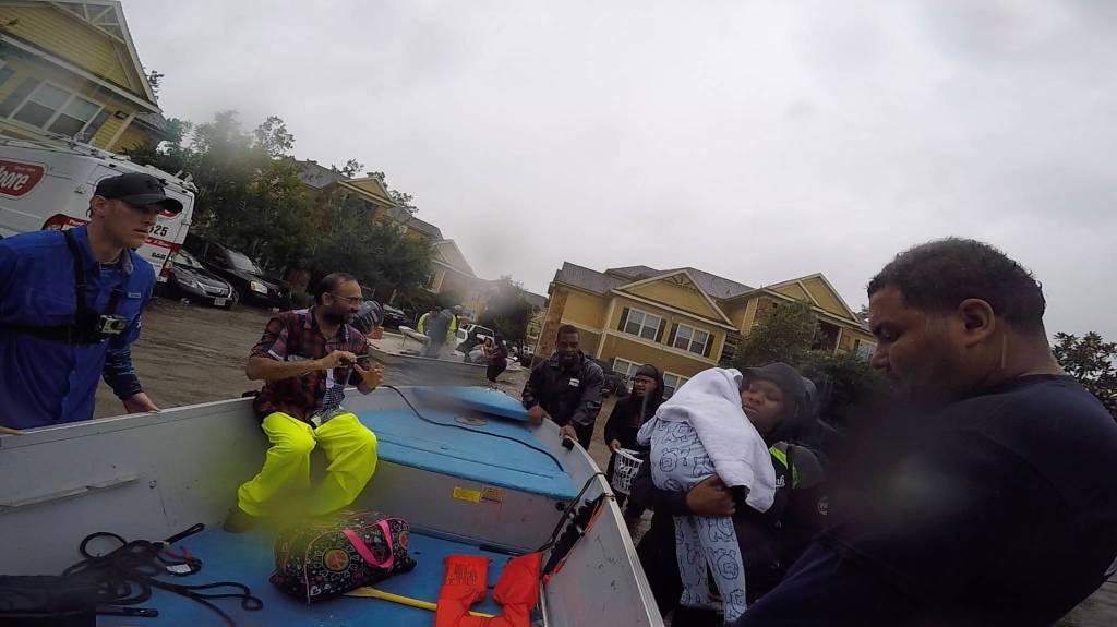 Former Anchor Point resident Chase McKinney, in blue shirt, helps rescue Houston-area flood survivors Aug. 28-30, 2017 in Texas. McKinney and a friend, Israel Lopez, picked up stranded victims and helped get them to high ground in their bass boat. (Photo provided)