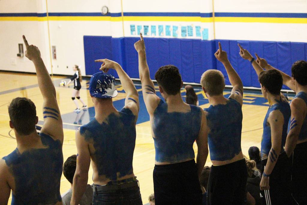 Supporters of the Homer varsity volleyball team hold up one finger, signaling that the team needs only one more point to win, during a game against Joe Redington Jr/Sr High School on Friday, Sept. 8, 2017 in the Alice Witte Gymnasium in Homer, Alaska. The Mariners topped the Huskies 3 sets to zero. (Photo by Megan Pacer/Homer News)