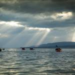 Derek Reynolds, Jessi Dullinger, Kim McNett, Lael Wilcox, Bernhard Brunner, and Daniel Countiss make their way in packrafts to Aurora Lagoon under beautiful evening light. (Photo by Bjørn Olson)