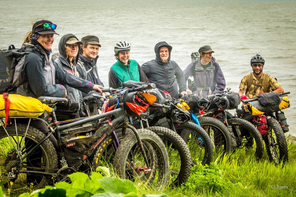 Jessi Dullinger, Margaret Drummer, Daniel Countiss, Lael Wilcox, Bjørn Olson, Kim McNett, and Derek Reynolds stand for a group photo before heading out on their three-day fat-bike and packraft trip around Kachemak Bay. (Photo by Bjørn Olson)
