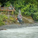 Jessi Dullinger, Lael Wilcox and their bikes and gear catch a ride on a tram across the Grewingk River. (Photo by Bjørn Olson)