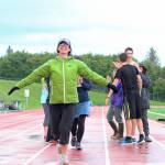Saundra Hudson crosses the finish line of her first mile run in six months during the Mariner Mile event Thursday, Sept. 14, 2017 at the high school track in Homer, Alaska. Hudson, an active member of and advocator for the Homer running community and teacher at Homer High School, experienced a head injury when she slipped on the ice running this past March, and Thursday&rsquo;s fundraising event for the Kachemak Bay Running Club was her first return to running since then. (Photo by Megan Pacer/Homer News)