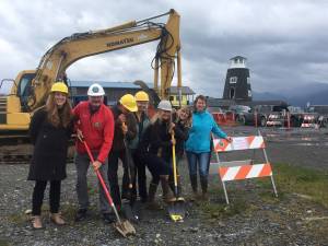 From left to right, Katie Koester, Bryan Hawkins, Gart Curtis, Joy Stewart, Polly Hess, Miranda Weiss and Denise Pitzman break ground on Sept. 6 for the start of The Boat House Maritime Pavillion on the Homer Spit at the site of the old harbormaster&rsquo;s office. The concrete foundation already has been poured, Most work will be done this fall. (Photo provided)