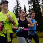Runners Kimberly Buskirk (left), Kate Swaby, and Candace Cartwright run in the Kenai River half-marathon on Sunday, Sept. 24, 2017 in Kenai, Alaska. (Photo by Ben Boettger/Peninsula Clarion)