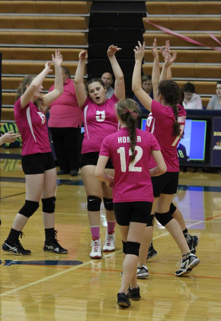 Members of the Homer Mariner varsity volleyball team celebrate earning a point against Anchorage Christian School during the game Saturday, Sept. 30, 2017 in the Alice Witte Gymnasium in Homer, Alaska. The Mariners fell to ACS zero sets to three. (Photo by Megan Pacer/Homer News)