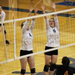 Junior Kelsea Scott (4) and sophomore Kirti Classen (8) jump to block a hit from the Seward varsity volleyball team during their game Friday, Sept. 22, 2017 at the Alice Witte Gymnasium in Homer, Alaska. The lady Mariners were defeated, winning one set while the Seahawks won three sets. (Photo by Megan Pacer/Homer News)