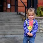 Aveline Russell, 2, shows off the sticker she got after going to Soldotna City Hall to vote with her family Tuesday, Oct. 3, 2017 in Soldotna, Alaska. Soldotna residents on Tuesday voted on two city council members and a mayor, all unopposed candidates, on one of three candidates for Kenai Peninsula Borough mayor and on two of the three borough propositions. (Photo by Elizabeth Earl/Peninsula Clarion)