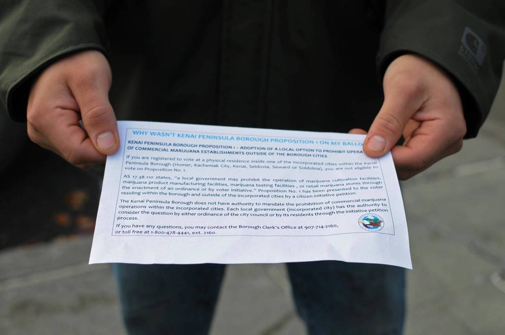 Toby Monroe of Soldotna holds out the paper he received after voting explaining why he was not able to vote on Kenai Peninsula Borough Proposition 1 on Tuesday in Soldotna. Proposition 1 asks voters outside the incorporated cities whether commercial cannabis operations should be legal in the borough outside the cities, but only voters registered outside city limits could vote on it. Soldotna residents on Tuesday voted on two city council members and a mayor, all unopposed candidates, on one of three candidates for Kenai Peninsula Borough mayor and on two of the three borough propositions. (Photo by Elizabeth Earl/Peninsula Clarion)