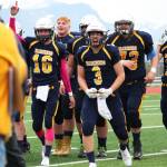 Seniors Justin Sumption (16) and Dawson Felde (3) come off the field celebrating with their teammates after defeating Ben Eielson High School in a playoff game Saturday, Oct. 7, 2017 at Homer High School in Homer, Alaska. The Mariners will now head to Palmer for the Division III state championship game. (Photo by Megan Pacer/Homer News)