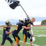 Senior Levi Smith gets a hug from a teammate as he walks of the field at Homer High School carrying a pirate flag Saturday, Oct. 7, 2017 following the varsity football team&rsquo;s win over Ben Eielson High School 33-21 in Homer, Alaska. The Mariners now head to the ASAA First National Bowl Series Division III Championship. (Photo by Megan Pacer/Homer News)