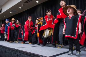 Natalie Soto, 2, helps sing with the All Nations Children Dancers as Juneau residents celebrate Indigenous Peoples Day at Elizabeth Peratrovich Hall on Monday, Oct. 9, 2017. (Michael Penn