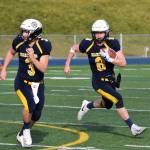 Homer quarterback Teddy Croft (8) gets a block from teammate Dawson Felde Saturday in the ASAA First National Bank Division III state championship against Utqiagvik at Machetanz Field in Palmer. (Photo by Joey Klecka/Peninsula Clarion)