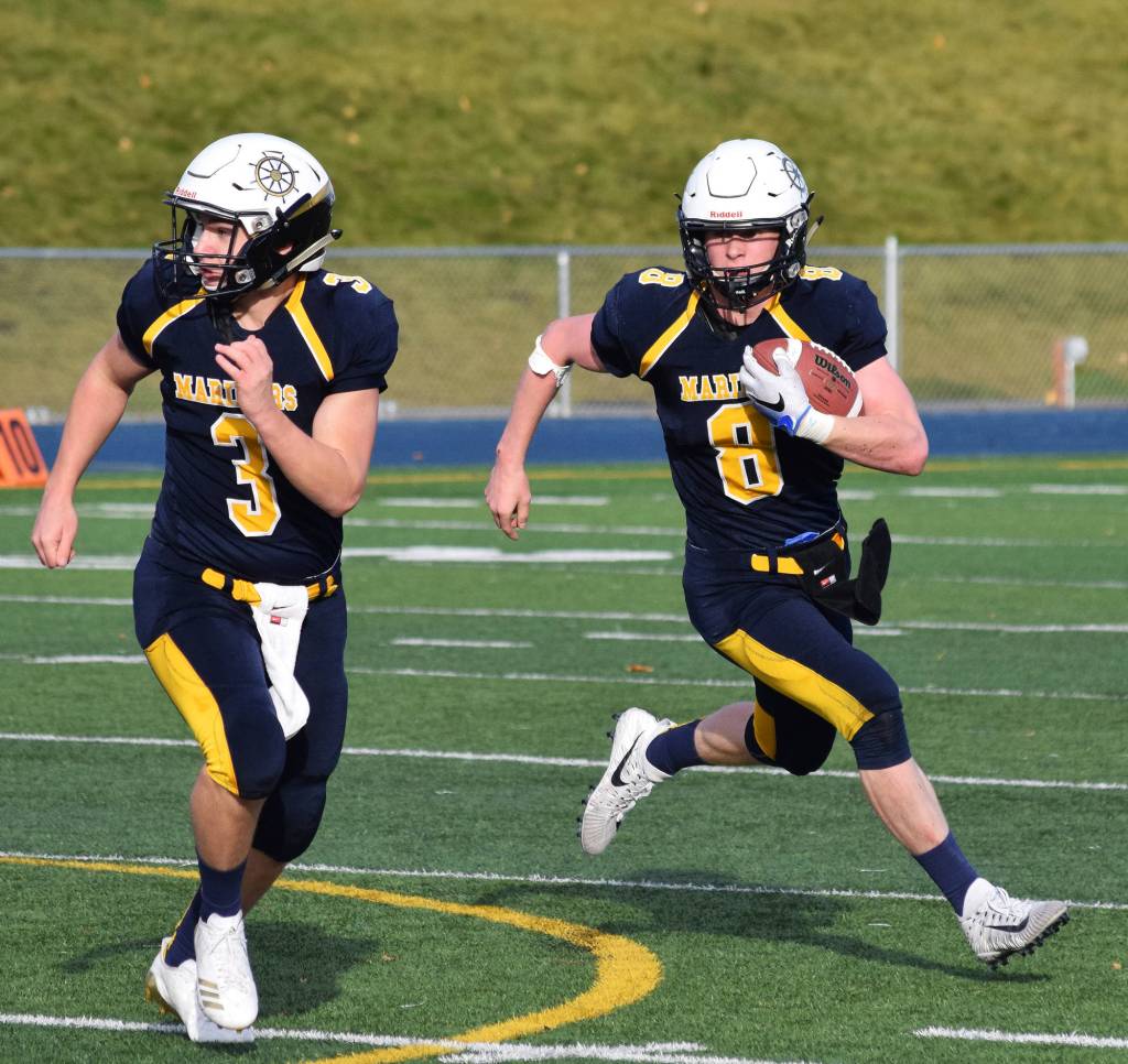 Homer quarterback Teddy Croft (8) gets a block from teammate Dawson Felde Saturday in the ASAA First National Bank Division III state championship against Utqiagvik at Machetanz Field in Palmer. (Photo by Joey Klecka/Peninsula Clarion)