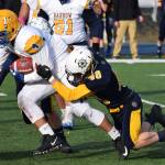 Homer senior Chris Cudaback (48) tackles Utqiagvik running back Ben Heather Saturday in the ASAA First National Bank Division III state championship at Machetanz Field in Palmer. (Photo by Joey Klecka/Peninsula Clarion)