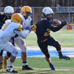 Homer sophomore Noah Fisk (right) tries to evade a pair of Utqiagvik tacklers Saturday in the ASAA First National Bank Division III state championship at Machetanz Field in Palmer. (Photo by Joey Klecka/Peninsula Clarion)