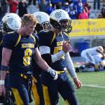 Homer senior Teddy Croft (8) walks off the field with a group of teammates Saturday while the Utqiagvik Whalers celebrate in the ASAA First National Bank Division III state championship at Machetanz Field in Palmer. (Photo by Joey Klecka/Peninsula Clarion)